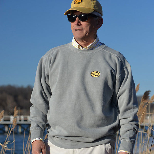man in gray Hook Life Crew fishing sweatshirt on the beach