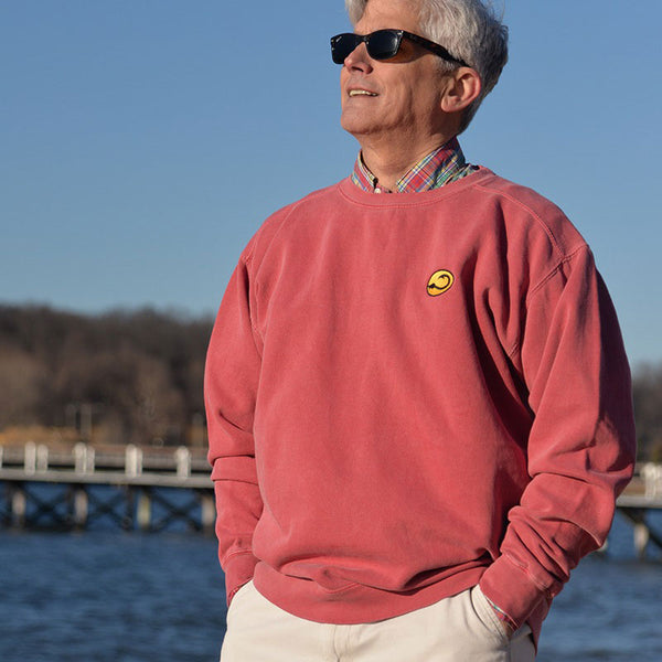 man wearing red Crew fishing sweatshirt by Hook Life at a marina