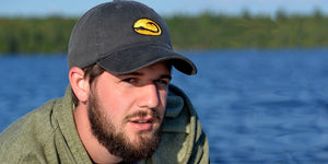 young man wearing Hook Life fishing cap on a lake