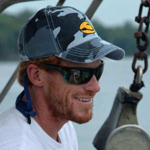 man wearing Water Camo fishing cap by Hook Life on lobster boat