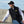 Load image into Gallery viewer, young man in black Fishers Fleece Vest by Hook Life on a sea wall
