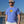 Load image into Gallery viewer, man wearing blue short sleeve Anglers Pride fishing tee shirt on a beach
