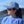 Load image into Gallery viewer, young woman wearing blue Beach fishing cap by Hook Life at a harbor
