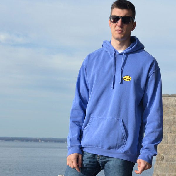 young man in blue Hookie fishing hoodie sweatshirt on sea wall