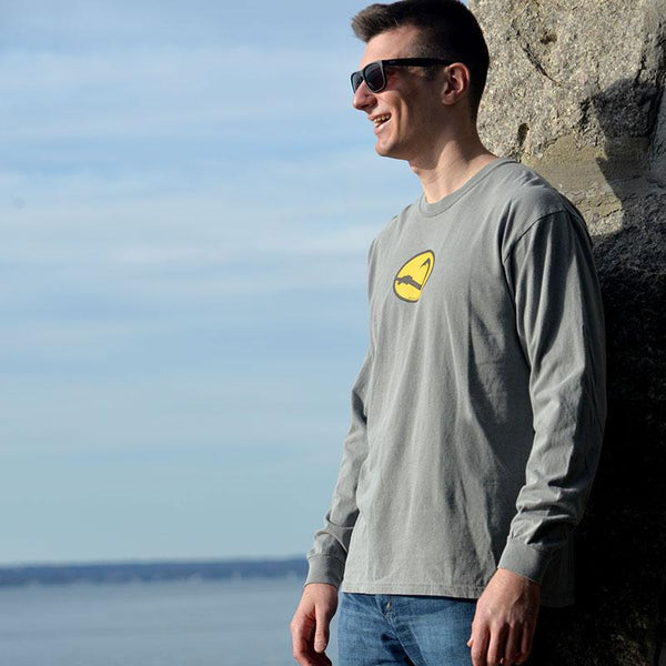 young man in gray long sleeve Anglers Pride fishing tee shirt on sea wall