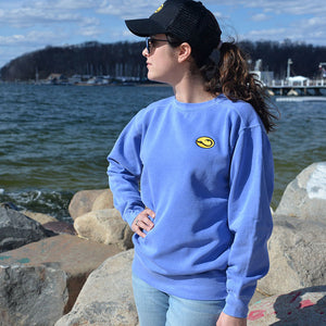 young woman in blue Hook Life Crew fishing Sweatshirt at a harbor