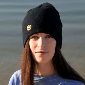 young woman wearing black Watch Cap by Hook Life on the water