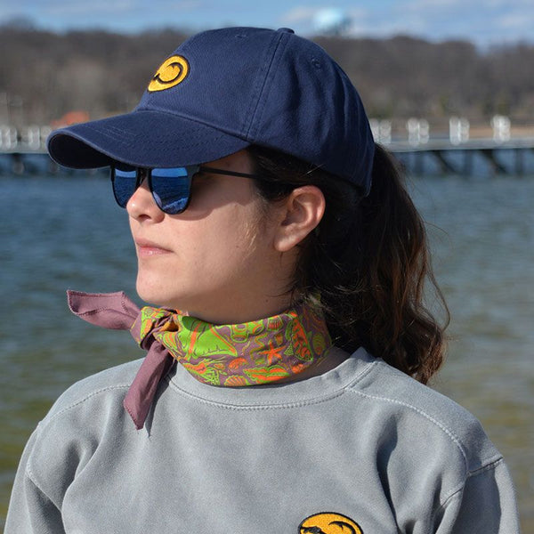 young woman wearing Anglers Pride Skipper fishing cap by Hook Life at a harbor