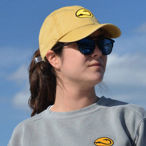 young woman wearing yellow Beach fishing cap by Hook Life